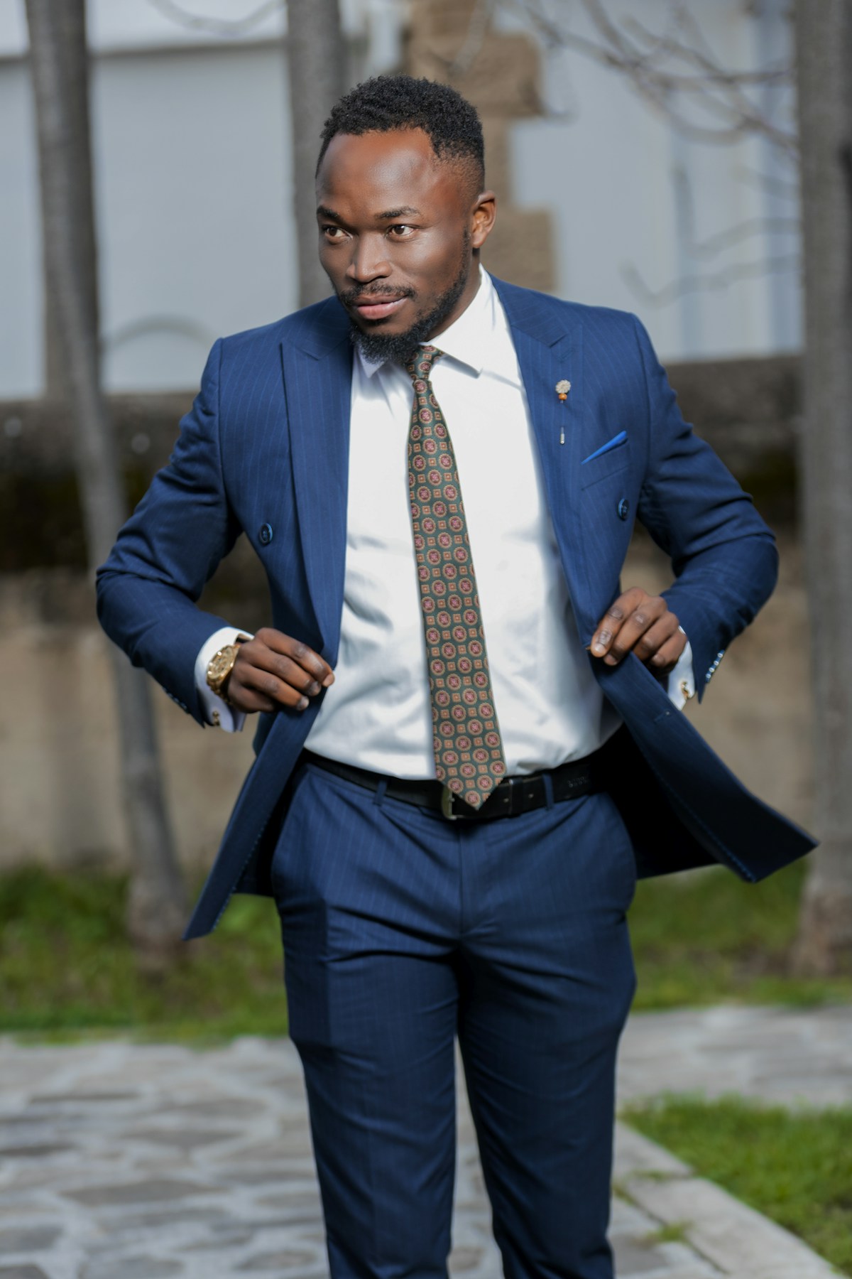 Model in a blue pinstripe suit with a green tie